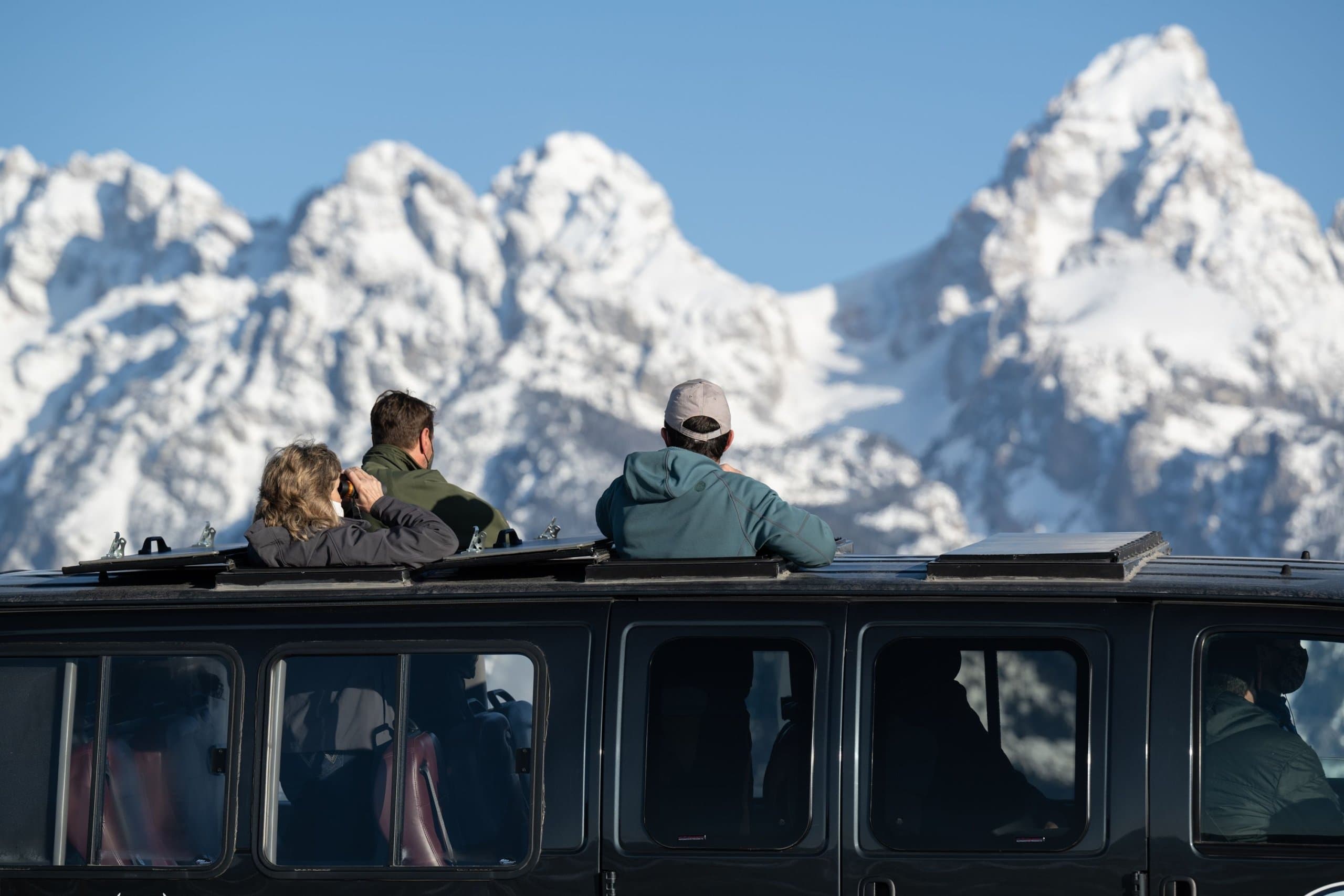 A group on a winter safari looking at the mountains in the distance near Jackson Hole, Wyoming.