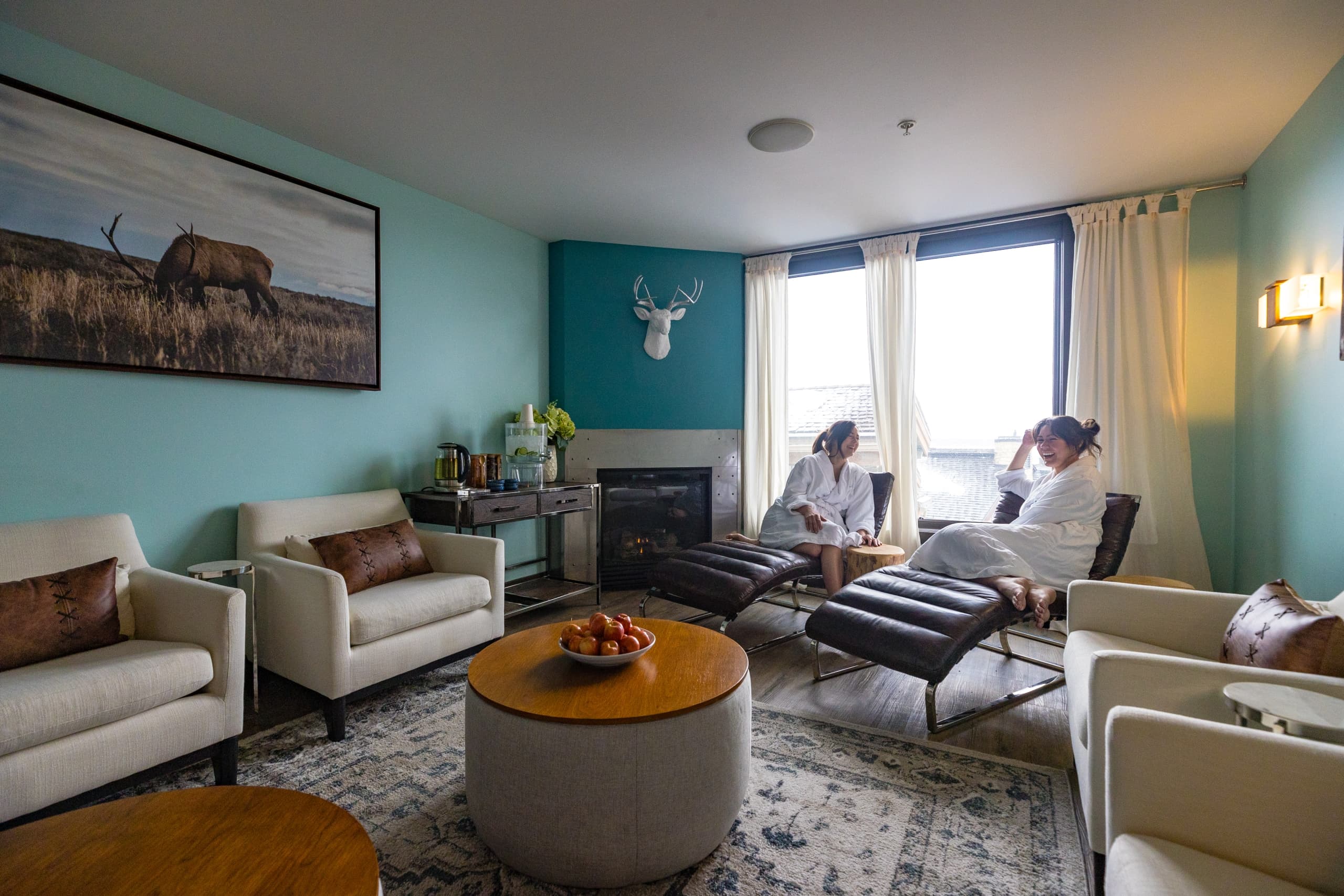 Two women relaxing in the lounge seating area of Chill Spa at Hotel Terra in Jackson Hole, Wyoming.