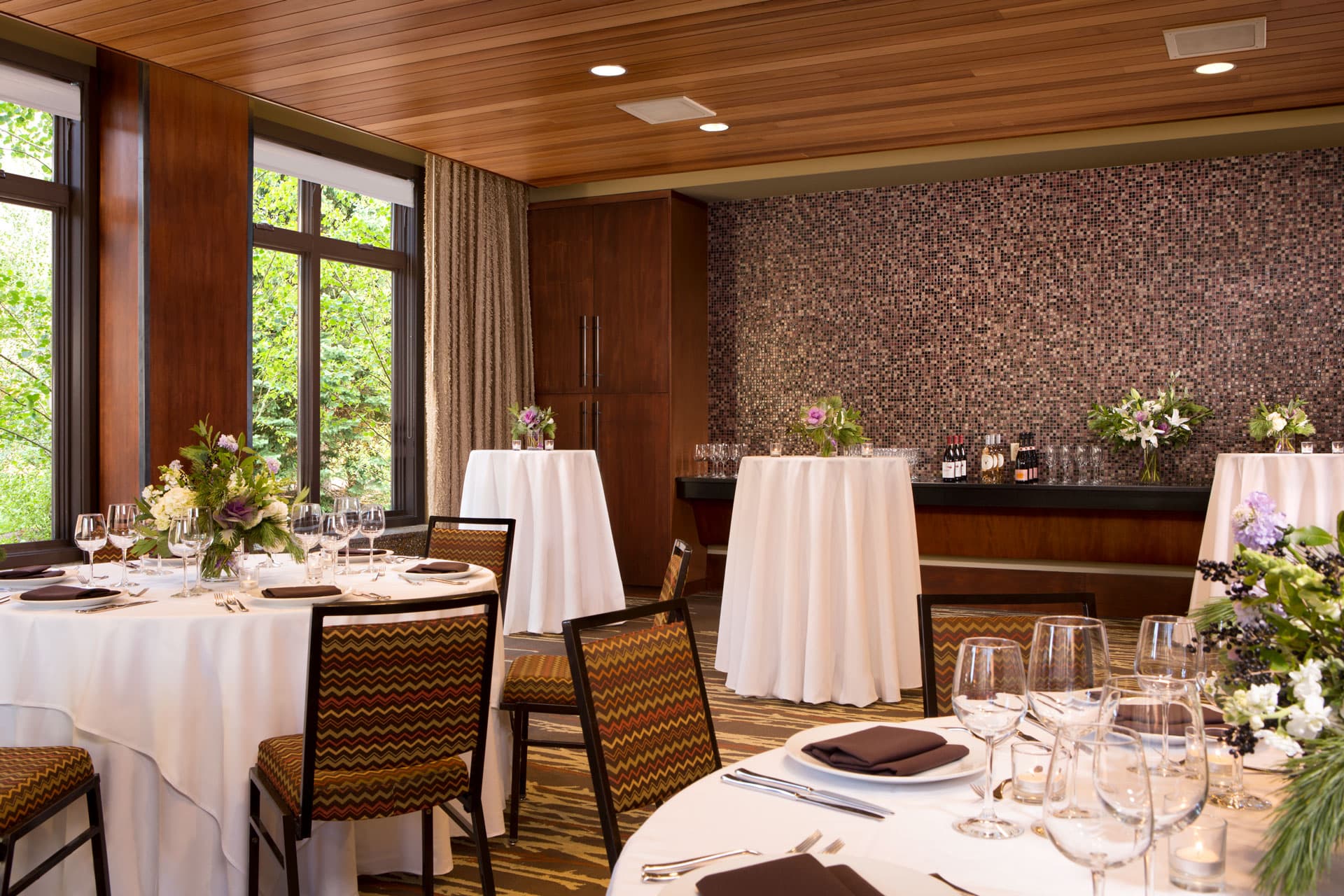The Albright Room set up for a formal wedding or gathering reception with seated and cocktail tables at Hotel Terra Jackson Hole.