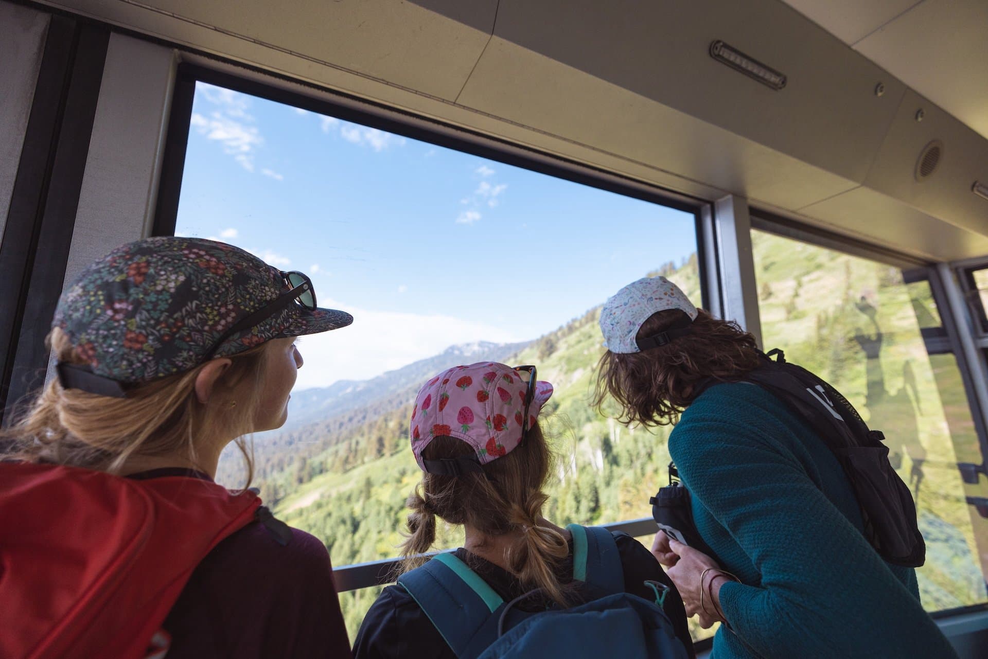 Children looking out of the window on the Jackson Hole tram ride during the summer