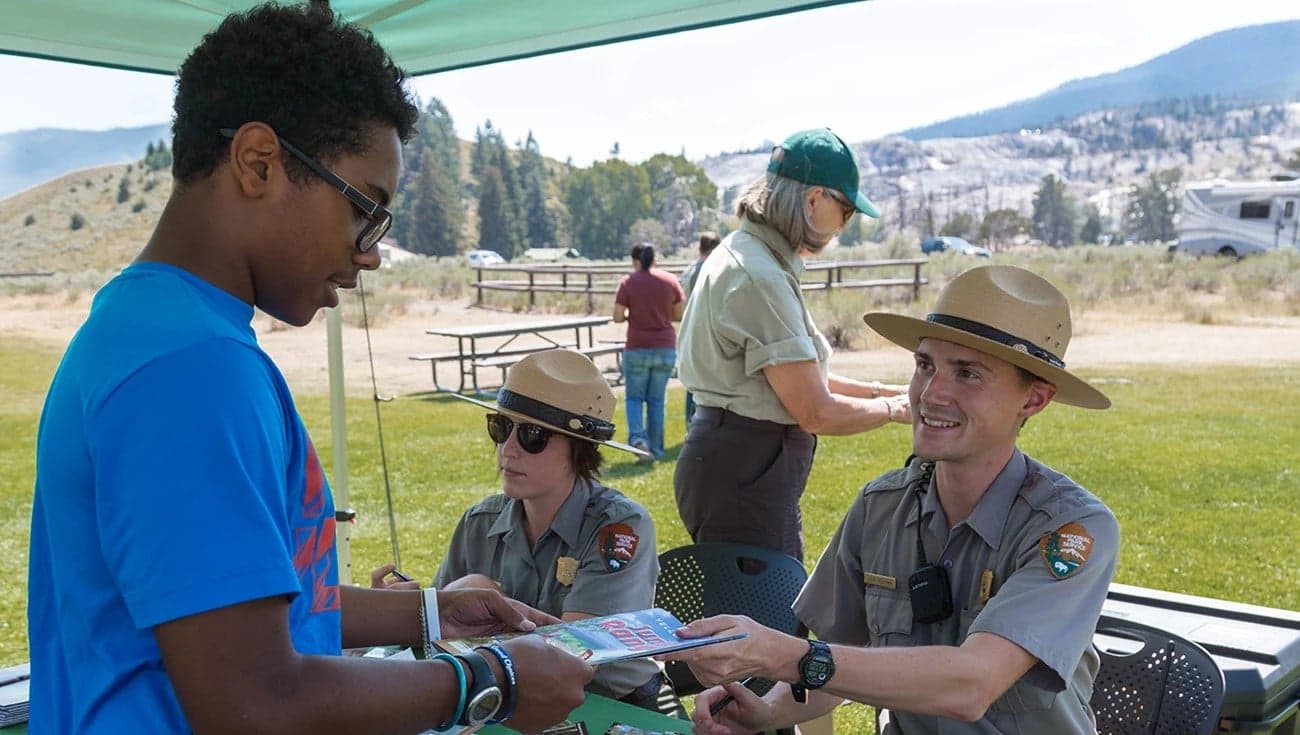 Kids checking in with park ranges at Yellowstone National Park.