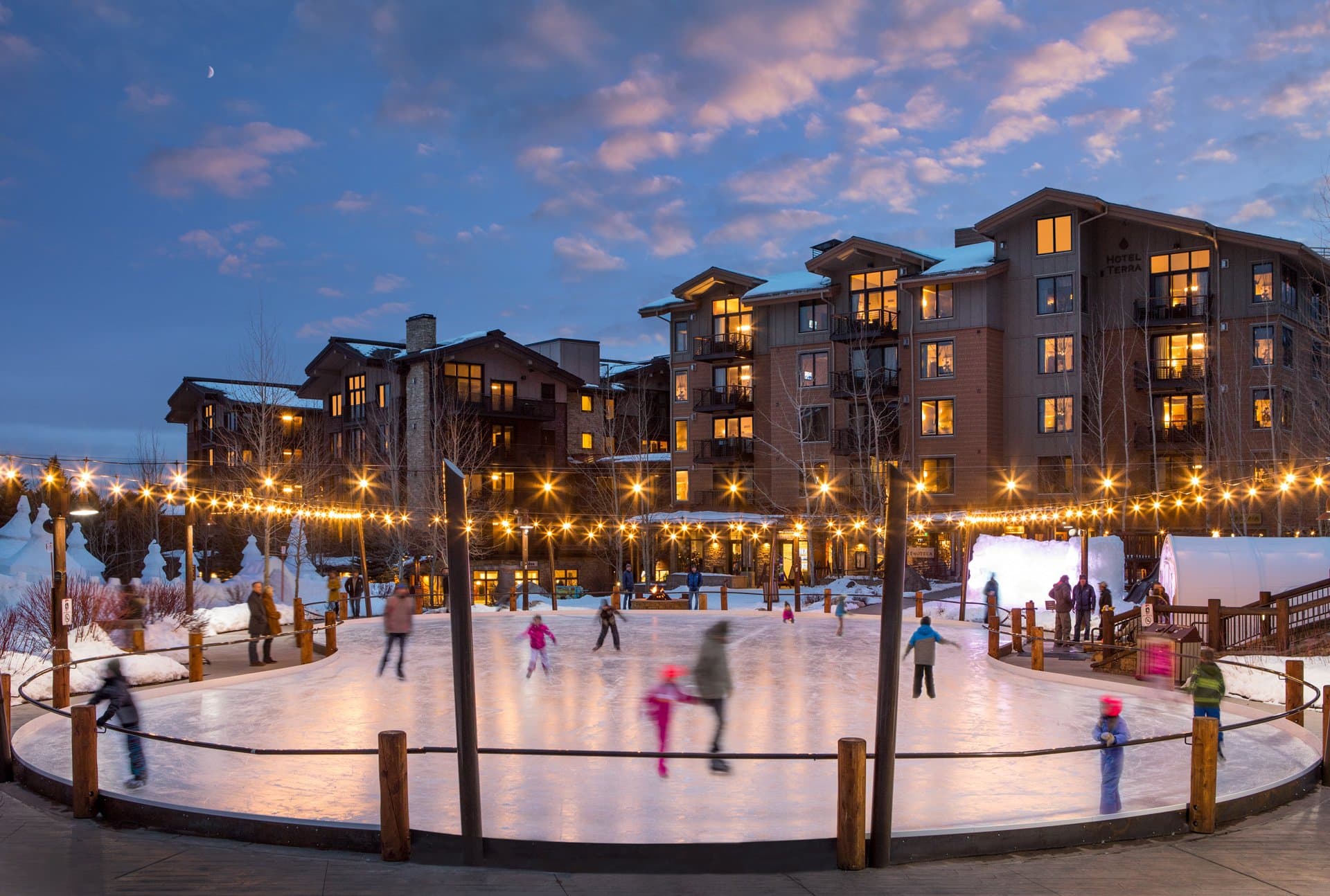 A wide view of the ice skating rink in front of Hotel Terra Mountain Resort in Teton Village, Wyoming.