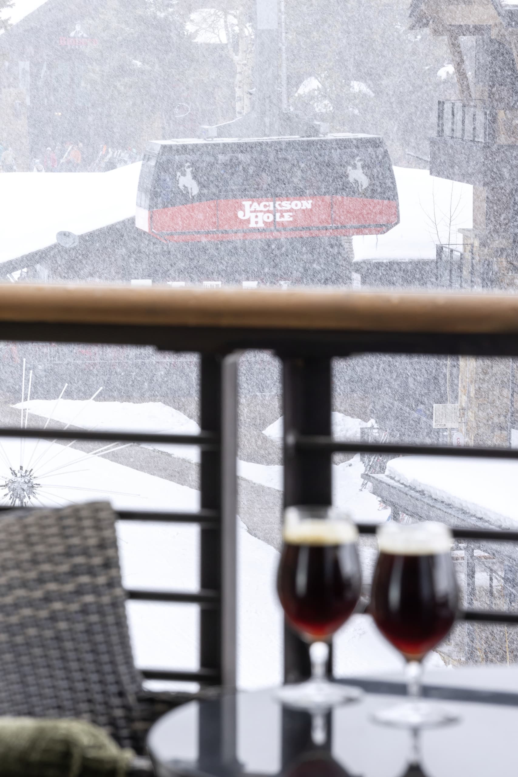 A balcony with 2 glasses of red wine on a table with a gondola in the background at Hotel Terra