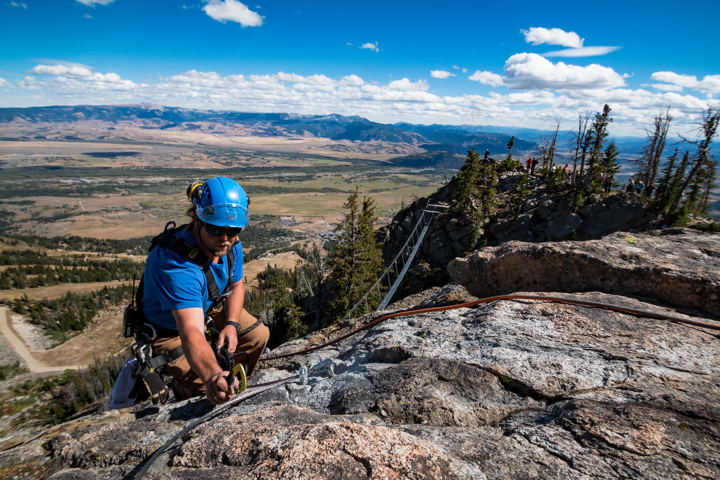 A man rock climbing and setting up harnesses at Hotel Terra