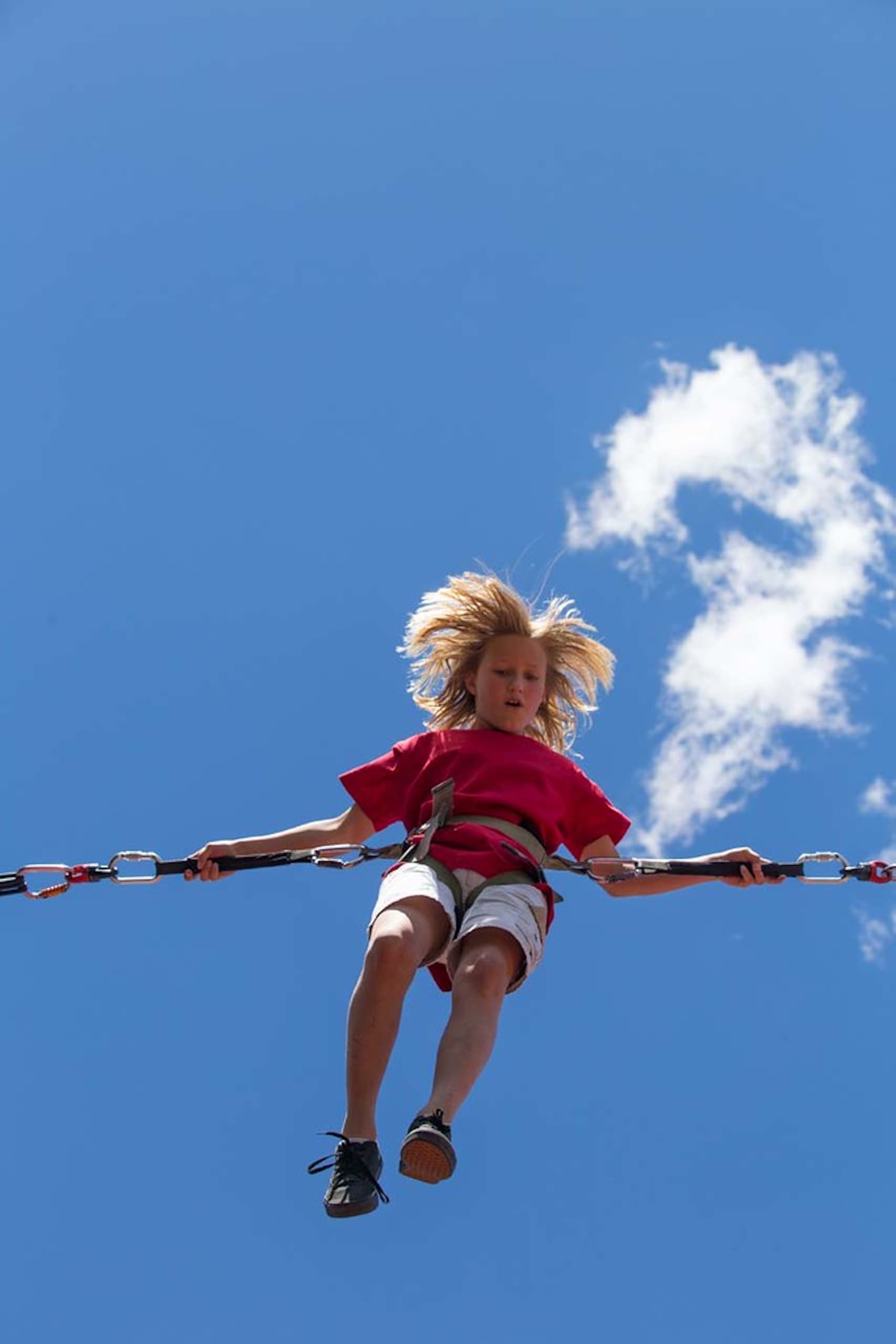 A child in the air enjoying a summer activity at Hotel Terra, Jackson Hole.