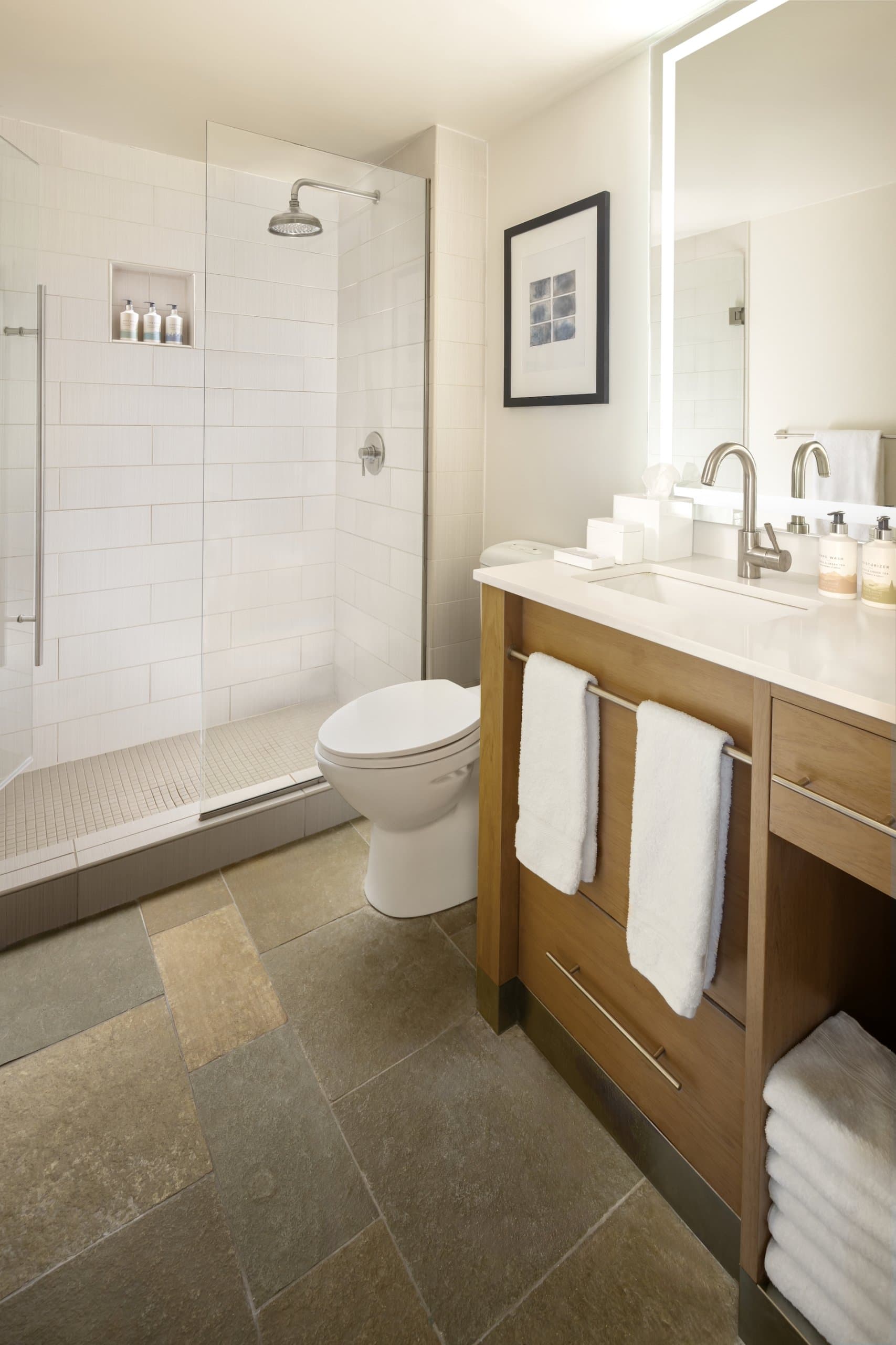 Shower, and vanity in a room at Terra Hotel