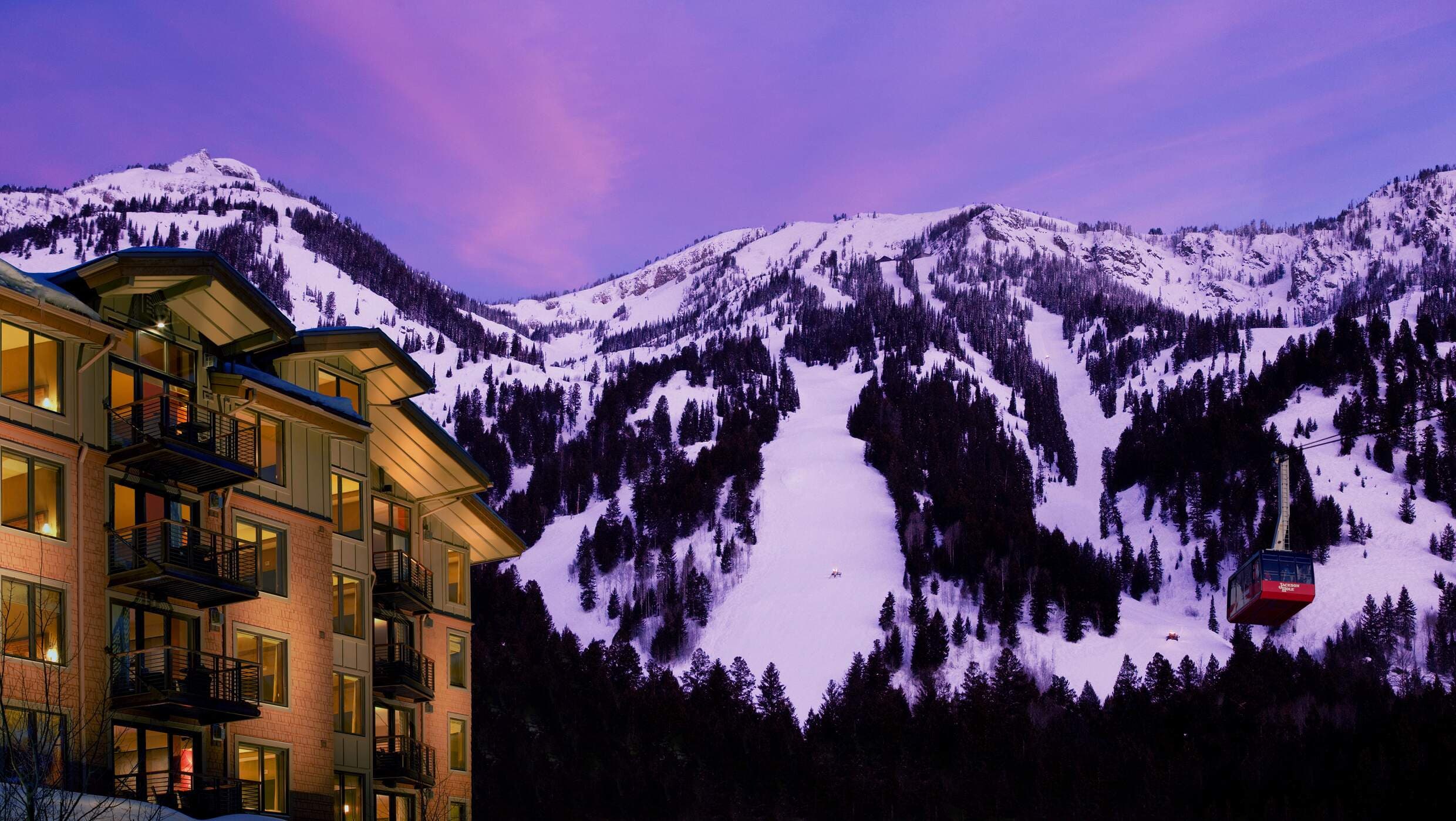 Evening view of the ski mountain with the tram going up past Hotel Terra Jackson Hole in Wyoming.