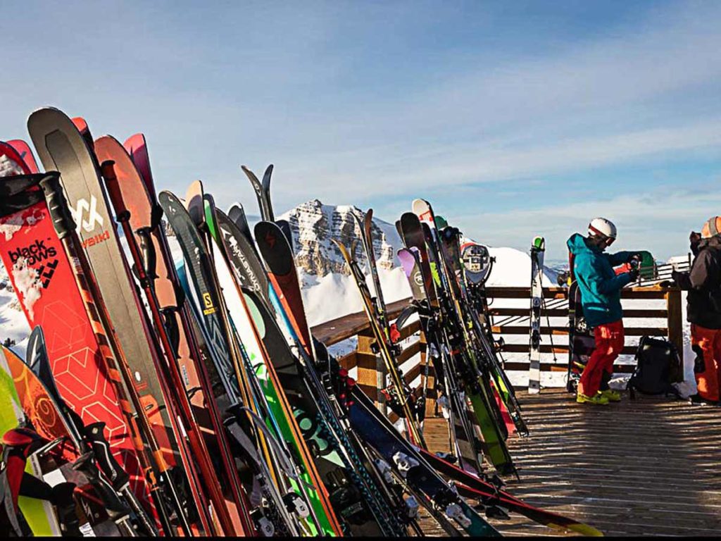 Skis up on a railing.