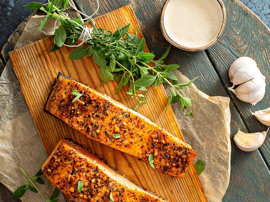 Salmon And Herbs On A Wooden Plank.
