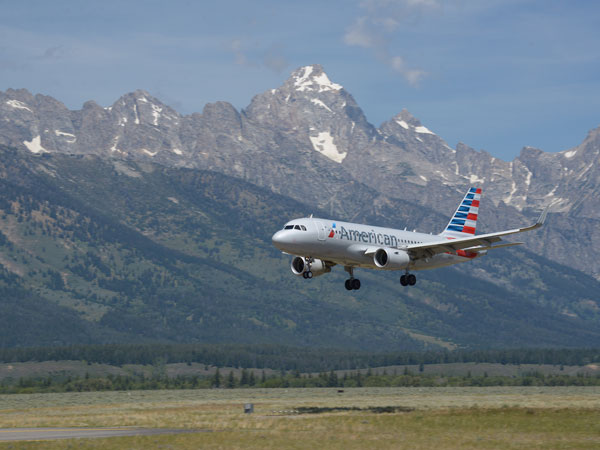 Airplane Flying In Front Of The Tetons.